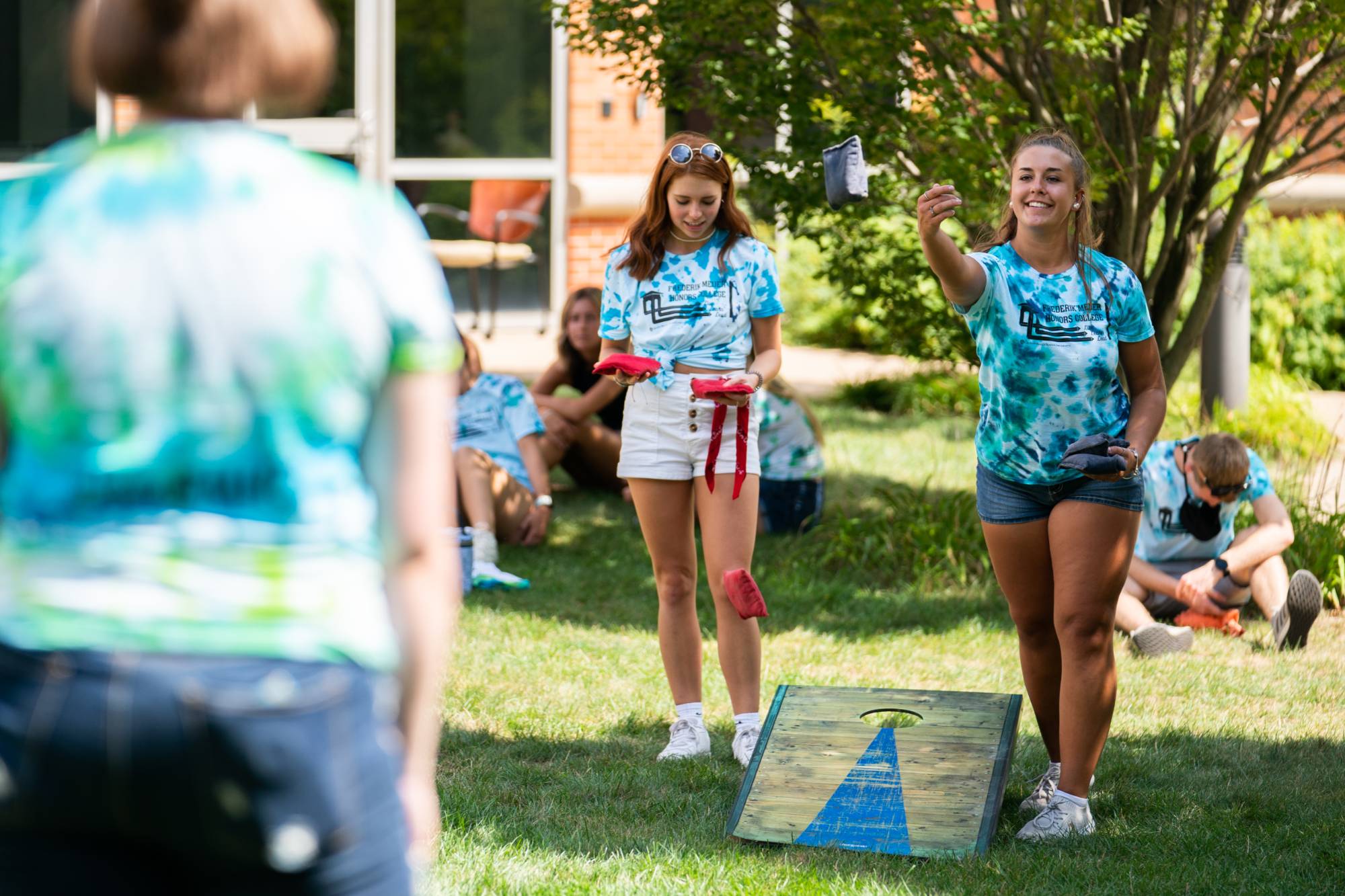Honors students playing corn hole together